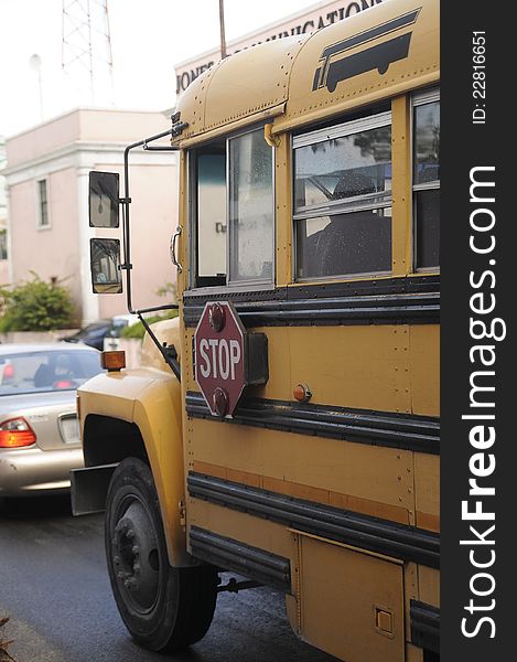 Yellow bus in traffic in Nassau, Bahamas