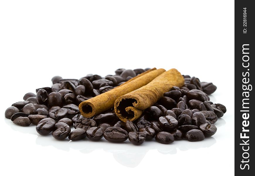 Cinnamon and coffee beans on white background. Cinnamon and coffee beans on white background