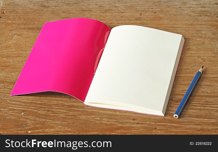 Red book on wooden background