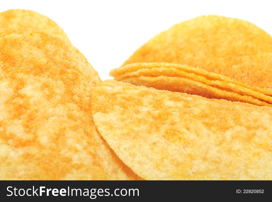 A close-up shot of potato chips (crisps) on a white background. A close-up shot of potato chips (crisps) on a white background