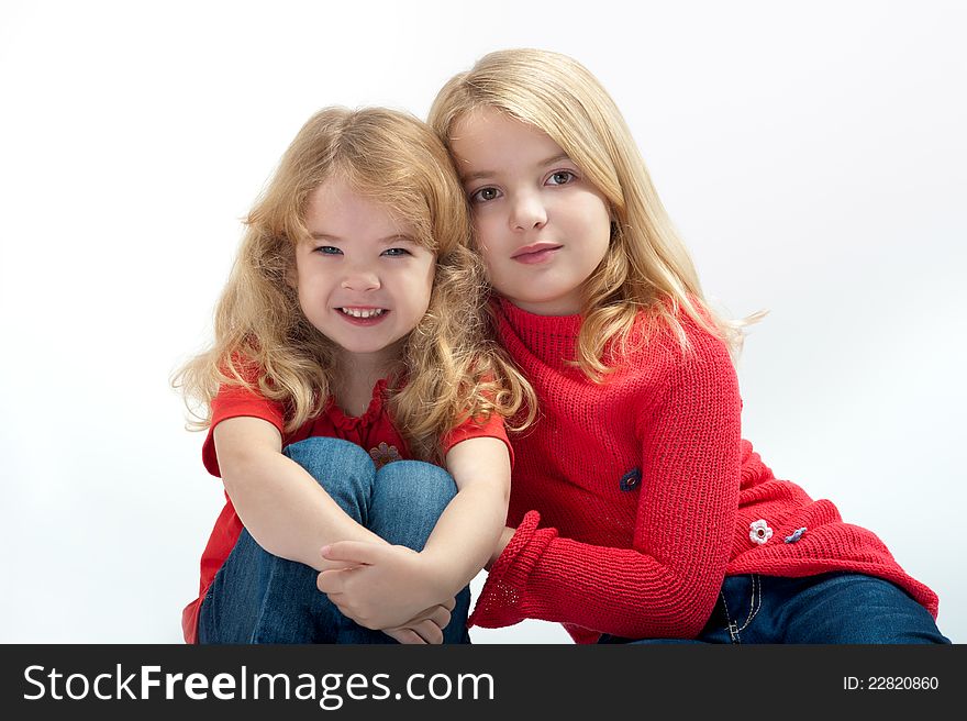 Two beautiful little girls on a white background. Two beautiful little girls on a white background