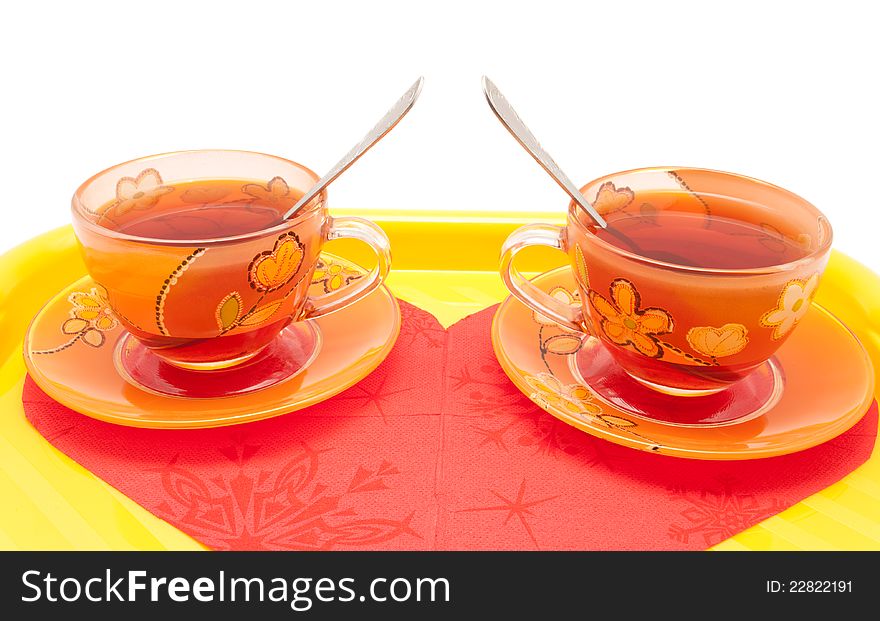 The couple of cup of tea  on the bright tray with heart-shaped napkin