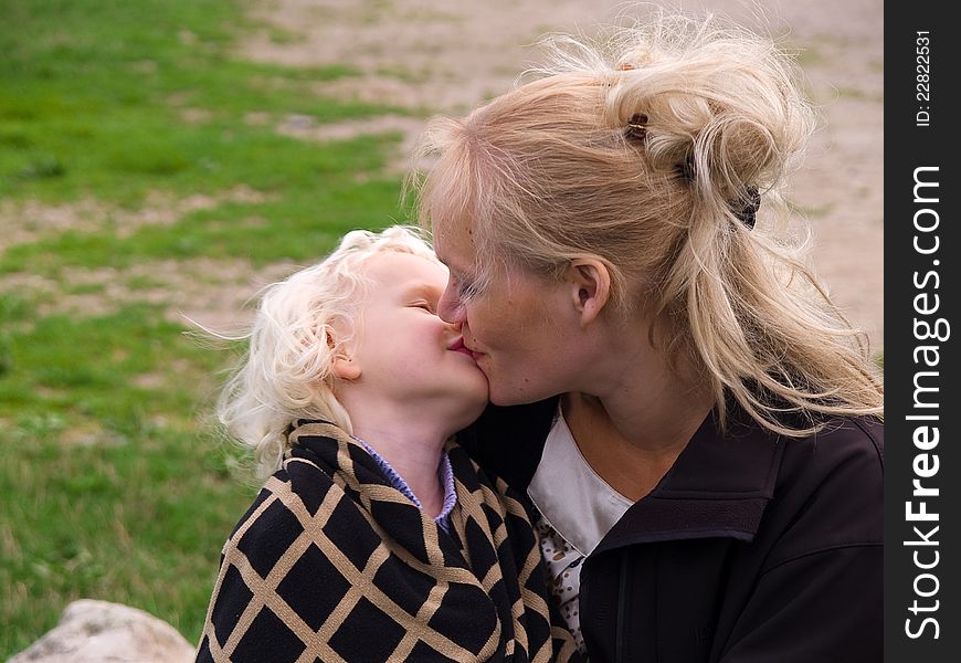 Close Up Of Affectionate Mother And Daughter hugging outdoors in nature