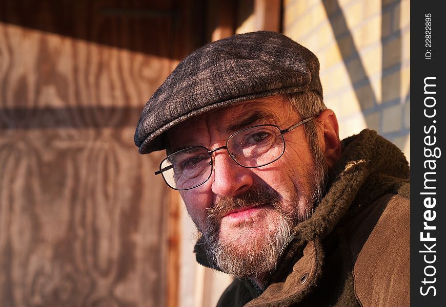 Closeup portrait of a happy smiling senior man with a hat outdoors. Closeup portrait of a happy smiling senior man with a hat outdoors