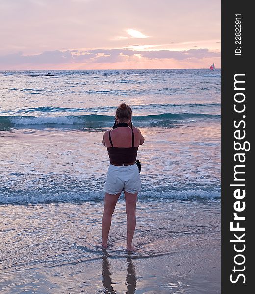 Woman On A Beach Taking Pictures With Camera