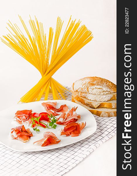 Italian prosciutto appetizer with pasta and italian bread.