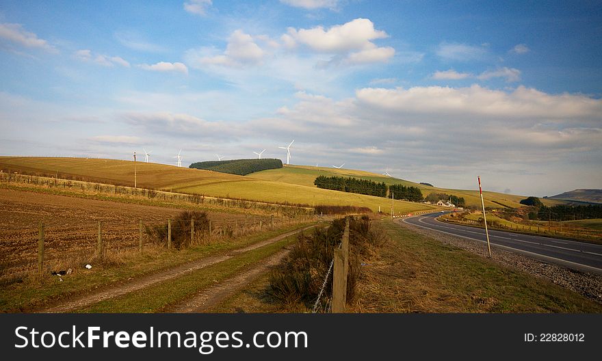 Wind turbines standing in a green field in Scotland. Wind turbines standing in a green field in Scotland.