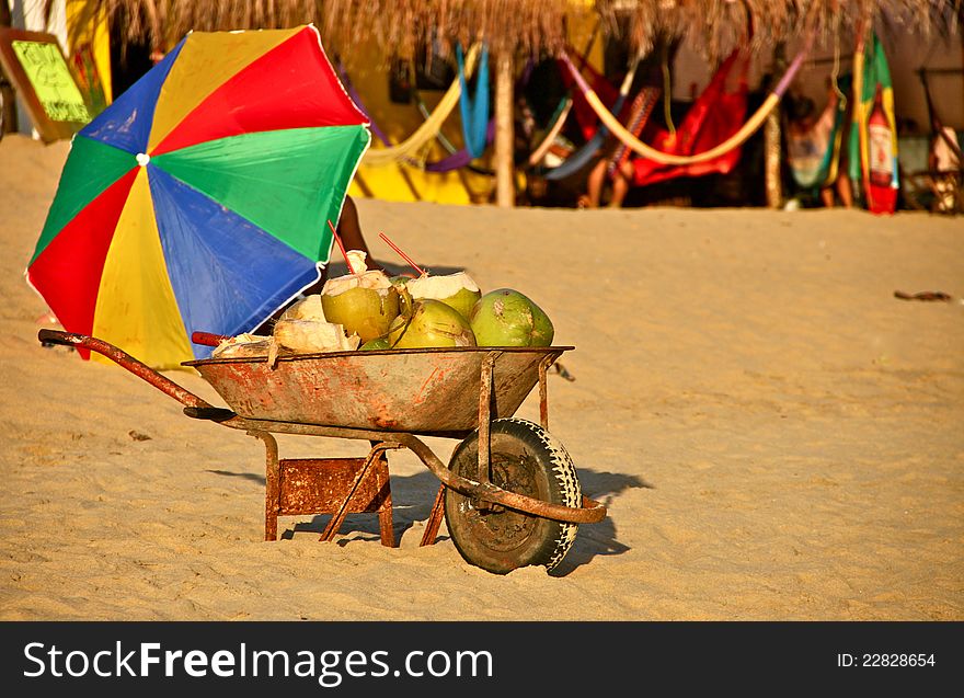 Rusty old pushcart with coconuts for sale on mexican beach. Rusty old pushcart with coconuts for sale on mexican beach.