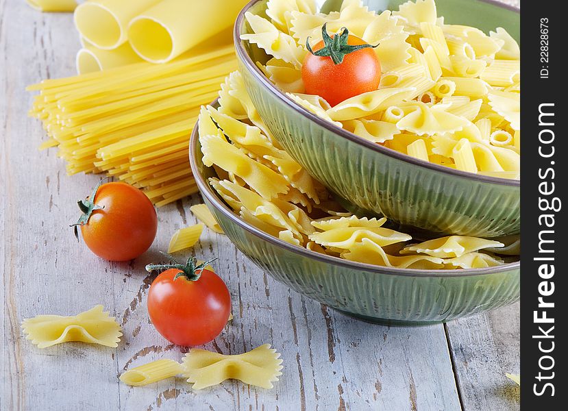 Italian pasta with tomatoes on awooden table