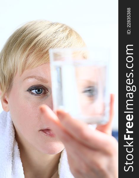 Image of a woman looking at a glass of water