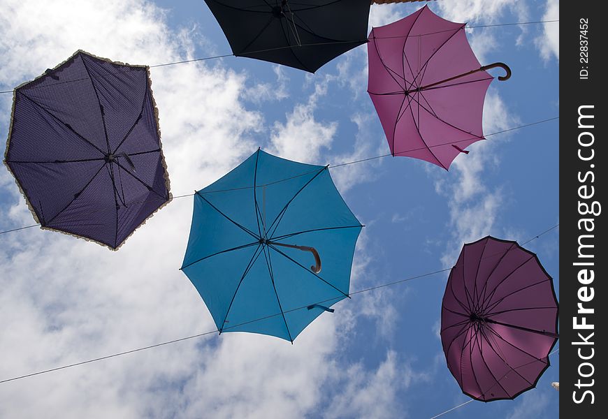 Umbrellas fly in the sky. Umbrellas fly in the sky