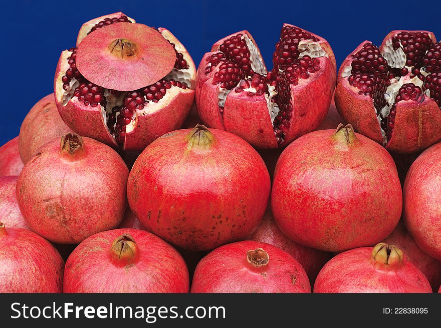 The background of the laid out mature grenades bright red. The background of the laid out mature grenades bright red