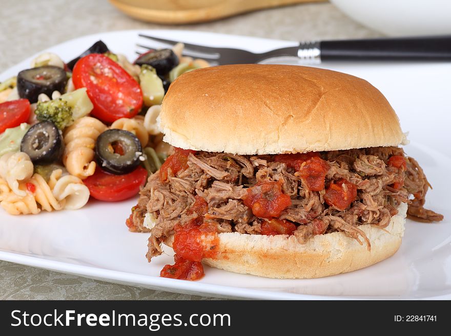 Shredded roast beef sandwich with pasta salad