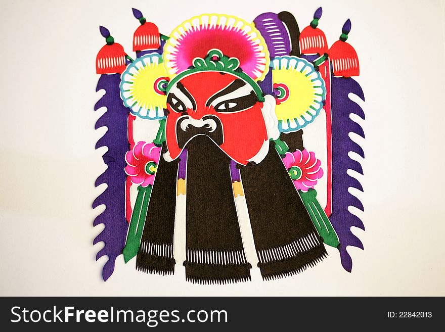 Paper-cutting is a traditional Chinese folk art. Paper-cut of a Peaking Opera Mask. Paper-cutting is a traditional Chinese folk art. Paper-cut of a Peaking Opera Mask