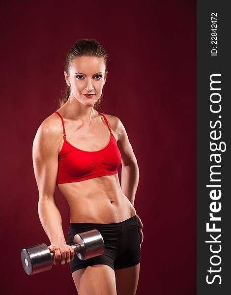 Young Fit Woman Lifting Dumbell