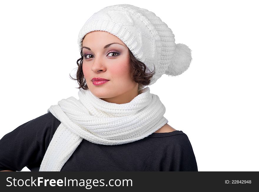Beautiful young girl in her winter warm clothing on white background