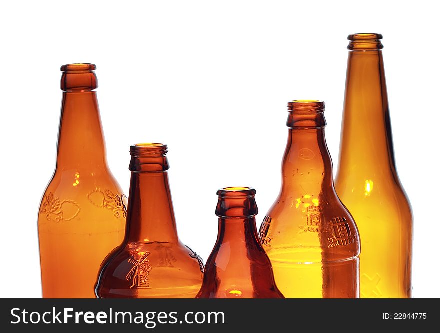 Image of empty brown beer glass bottles over white background