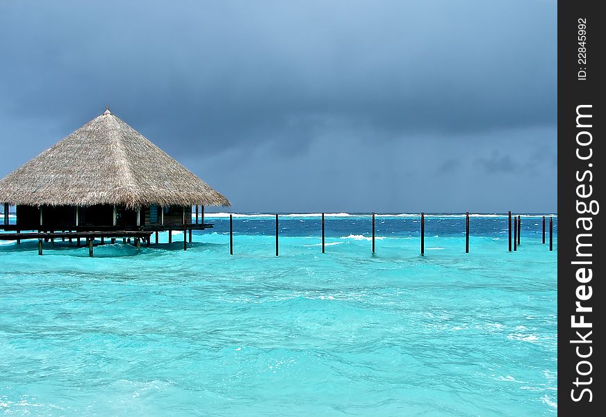 Small bungalows nestle on stilts above the ocean. It seems that in the event of a storm, it simply will take to the ocean. But it only seems so. Small bungalows nestle on stilts above the ocean. It seems that in the event of a storm, it simply will take to the ocean. But it only seems so.