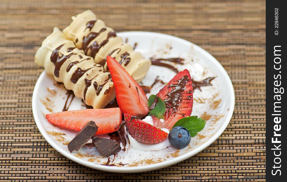 Delicious dessert with whipped creme and strawberry decorated chocolate. Delicious dessert with whipped creme and strawberry decorated chocolate