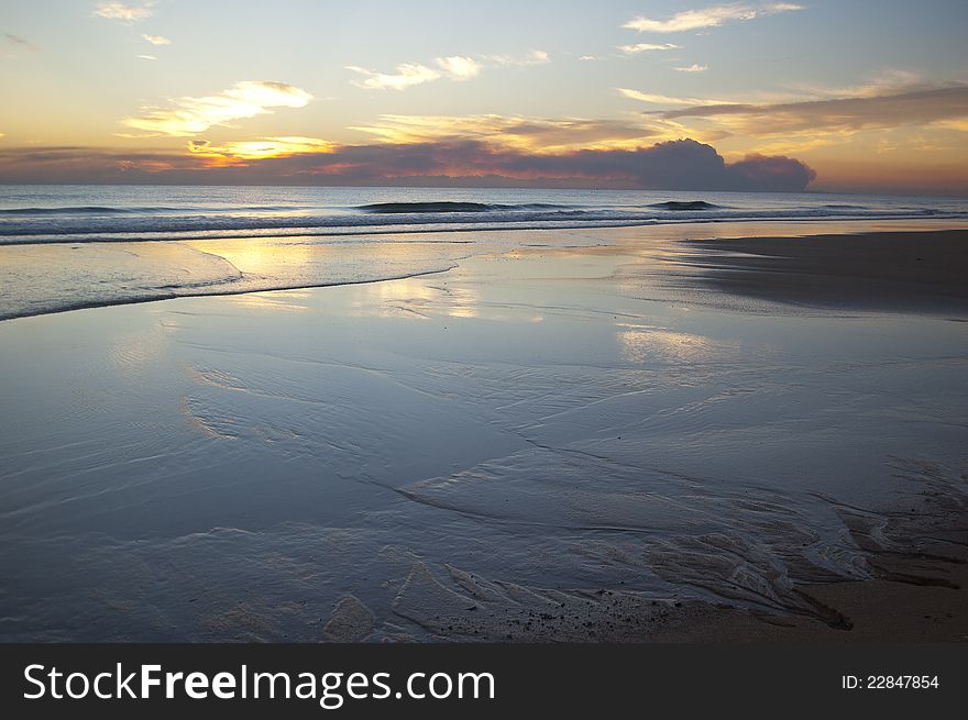 Sunrise on the ocean with reflections