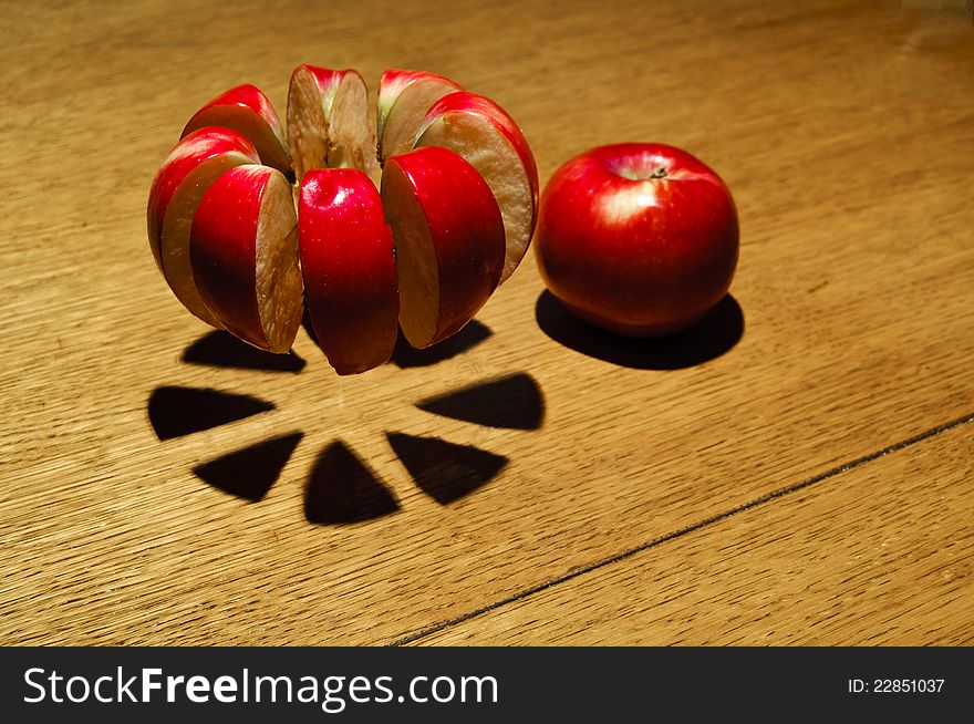Sliced apple pieces hovering above the table.