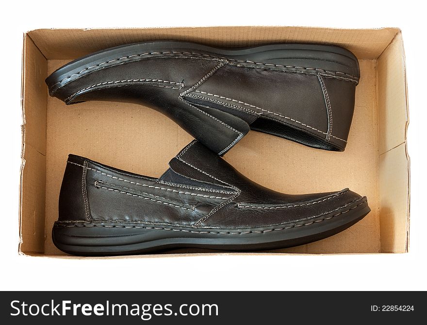 Men's casual shoes in a box over white background. Men's casual shoes in a box over white background