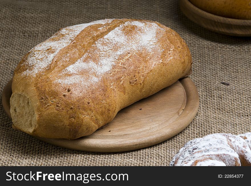 Fresh baked loaf of bread on a sacking