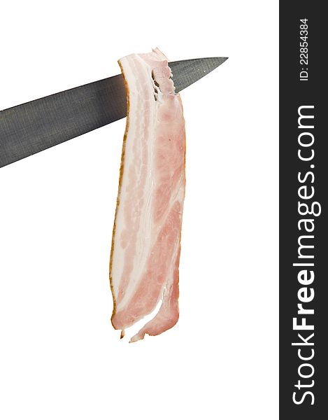 Raw bacon on knife over white background