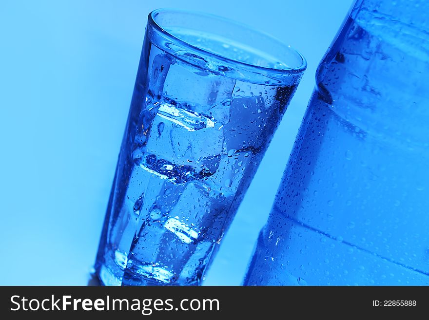 Crystal clear water with ice over blue background