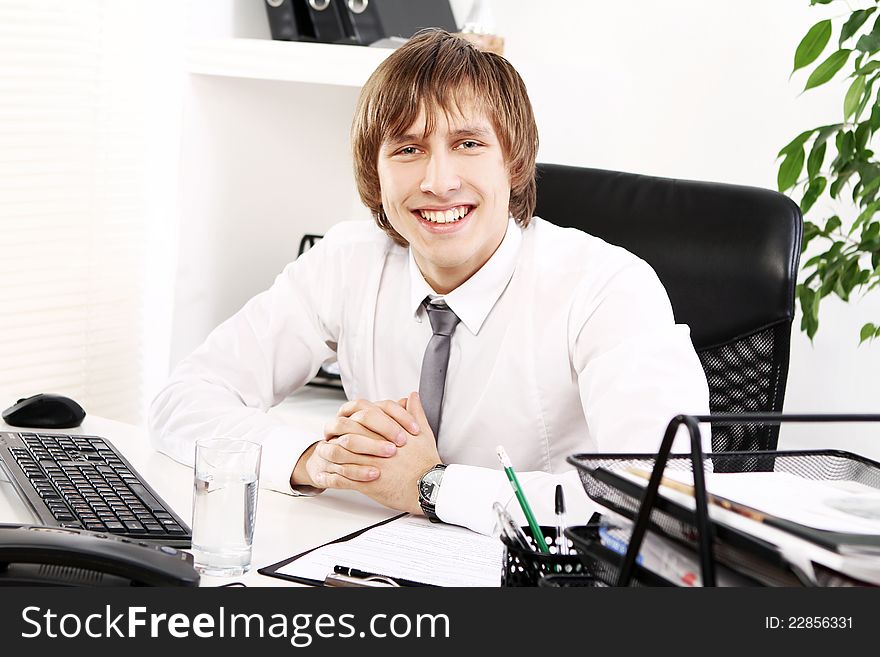 Young and successful businessman in his office