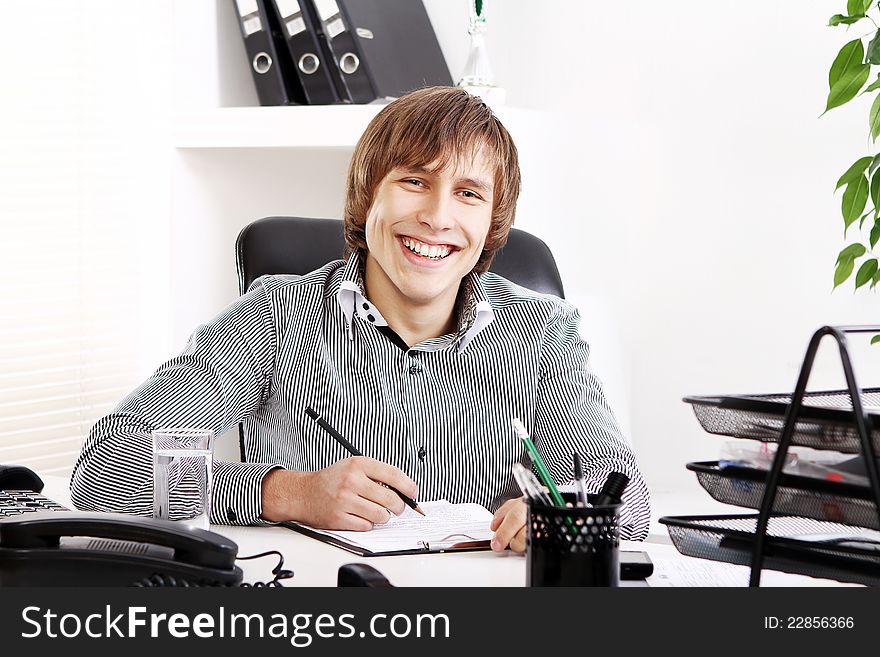 Young and successful businessman in his office