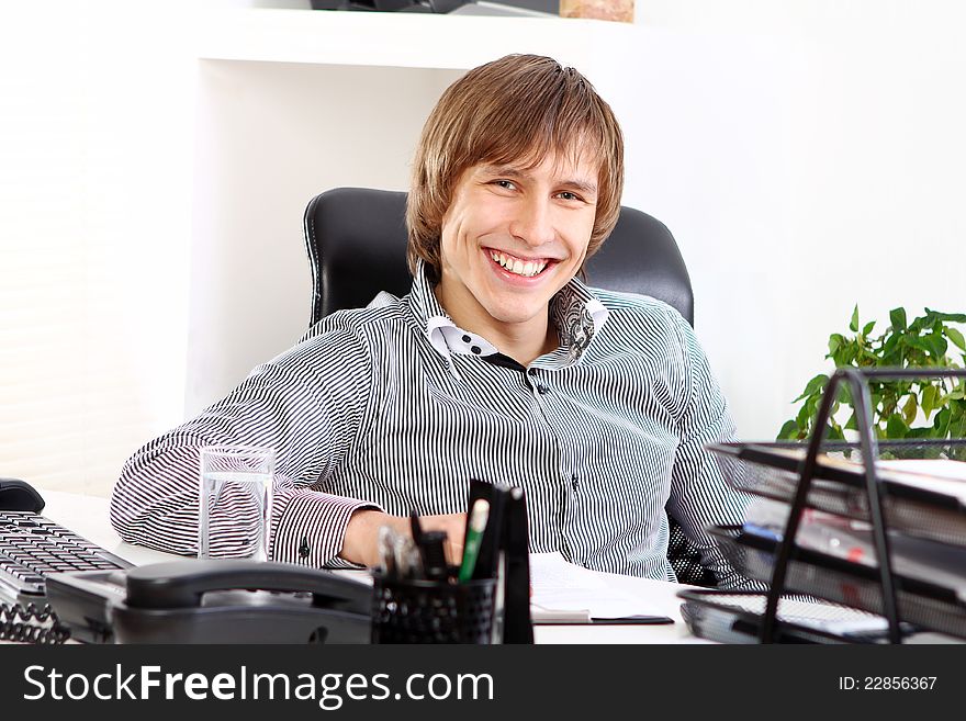 Young and successful businessman in his office
