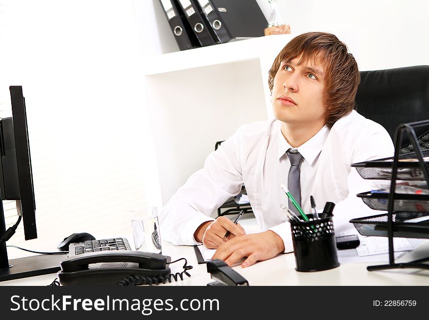 Young Businessman Thinking In Office