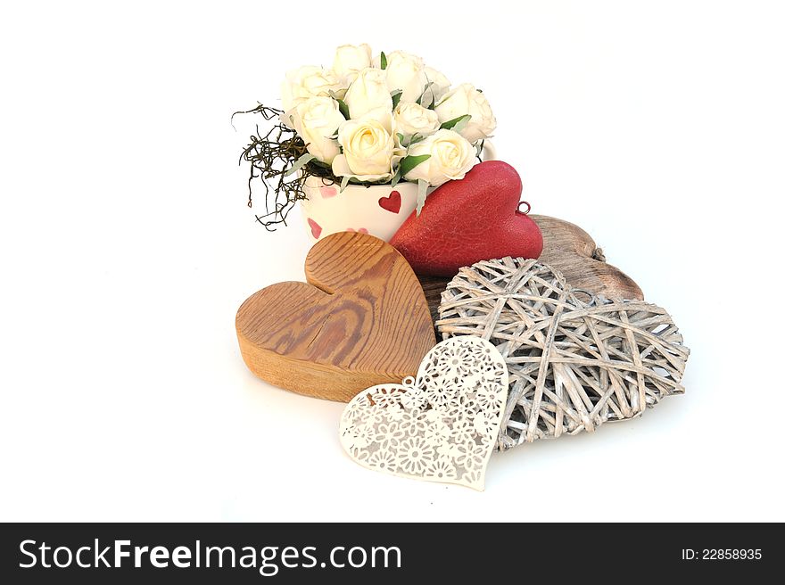 Pretty cream roses in a teacup and hearts. Pretty cream roses in a teacup and hearts