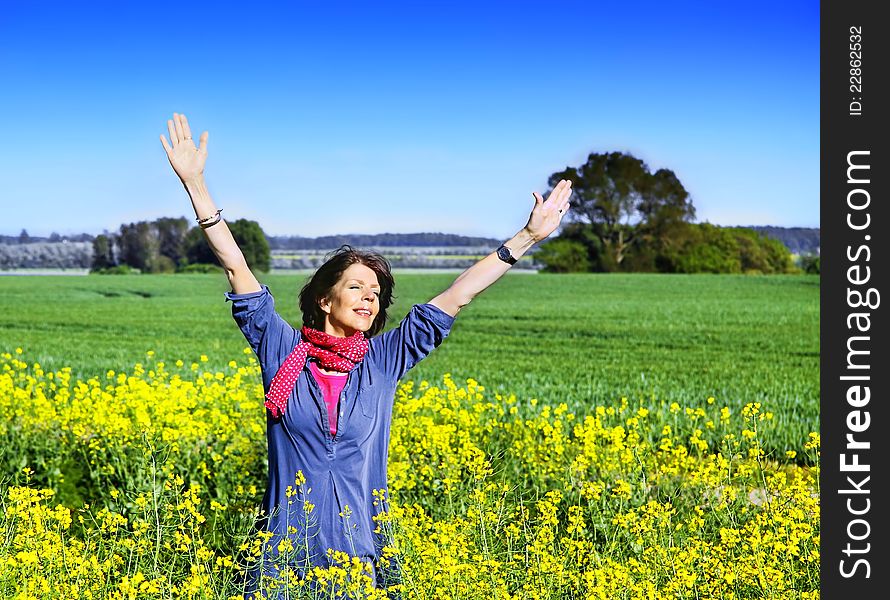 Happy woman in a field with stretching arms, full of joy. Happy woman in a field with stretching arms, full of joy