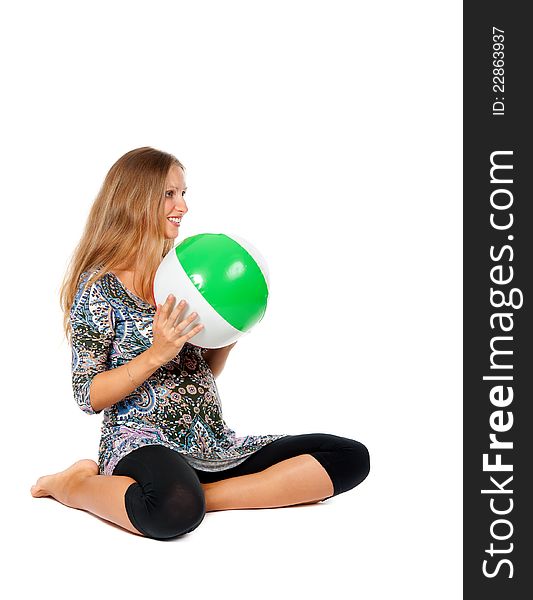 Pregnant girl in an inflatable ball color in the studio on a white background