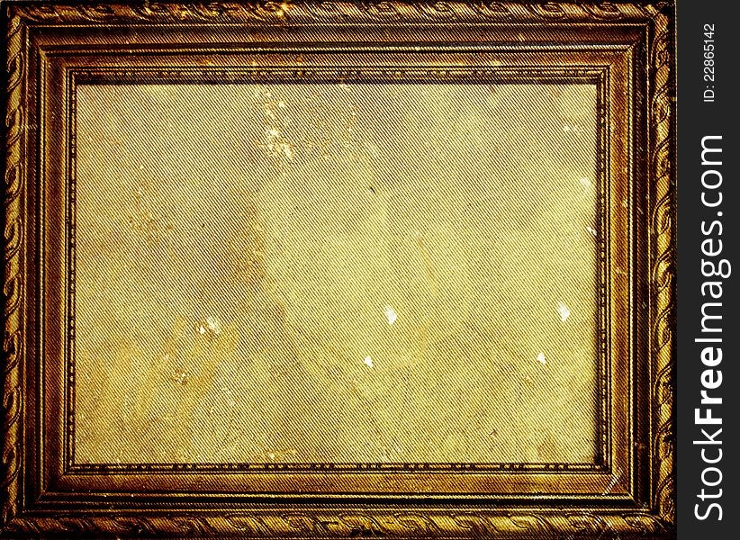 Old antique golden frame on grunge wall