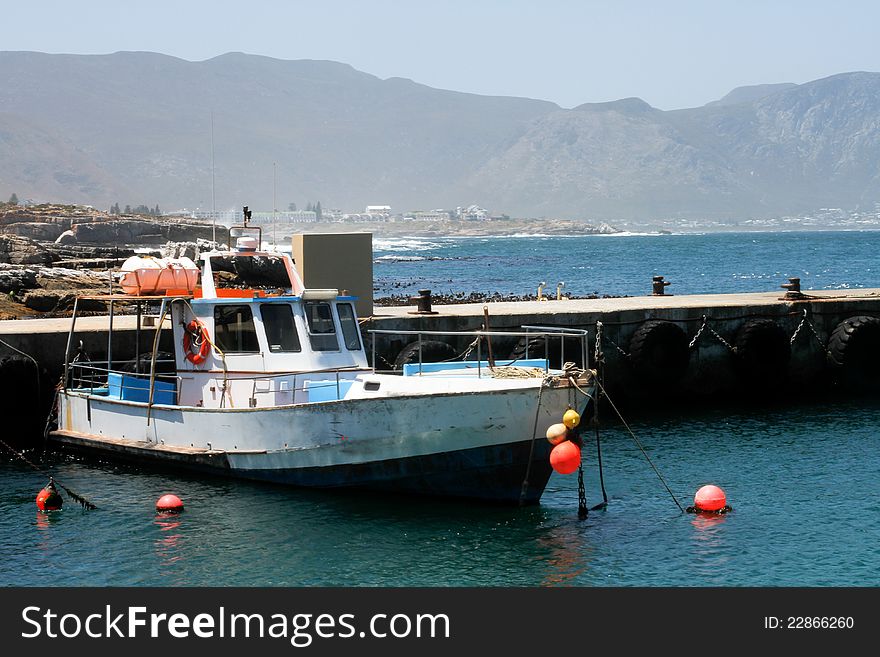 Small private fishing trawler moored in a scenic harbour. Small private fishing trawler moored in a scenic harbour