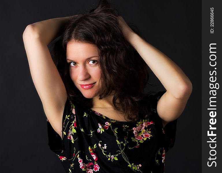 Portrait of young pretty woman in studio on black background