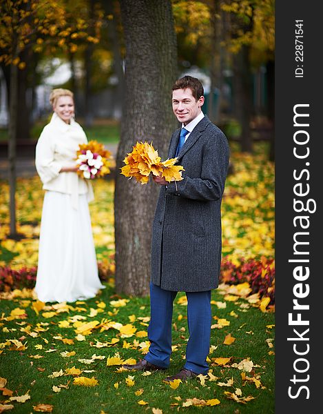 Bride and groom with a maple leaf on a wedding walk