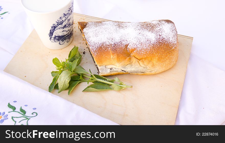 Strudel with poppy seeds and cup of milk