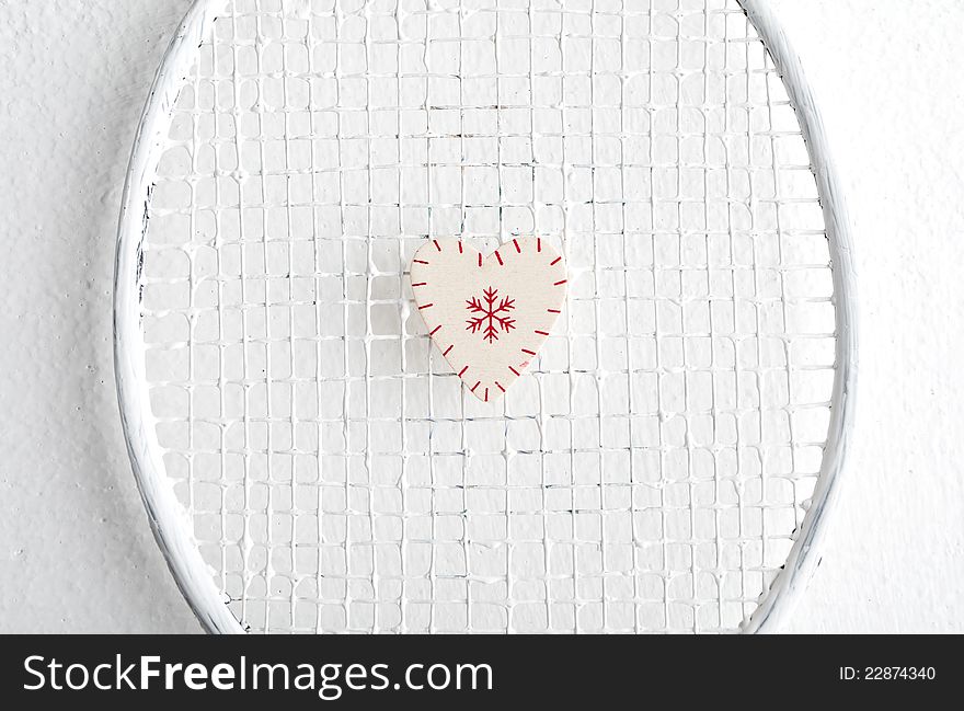 Wooden heart with snowflakes painted on the grid. Wooden heart with snowflakes painted on the grid