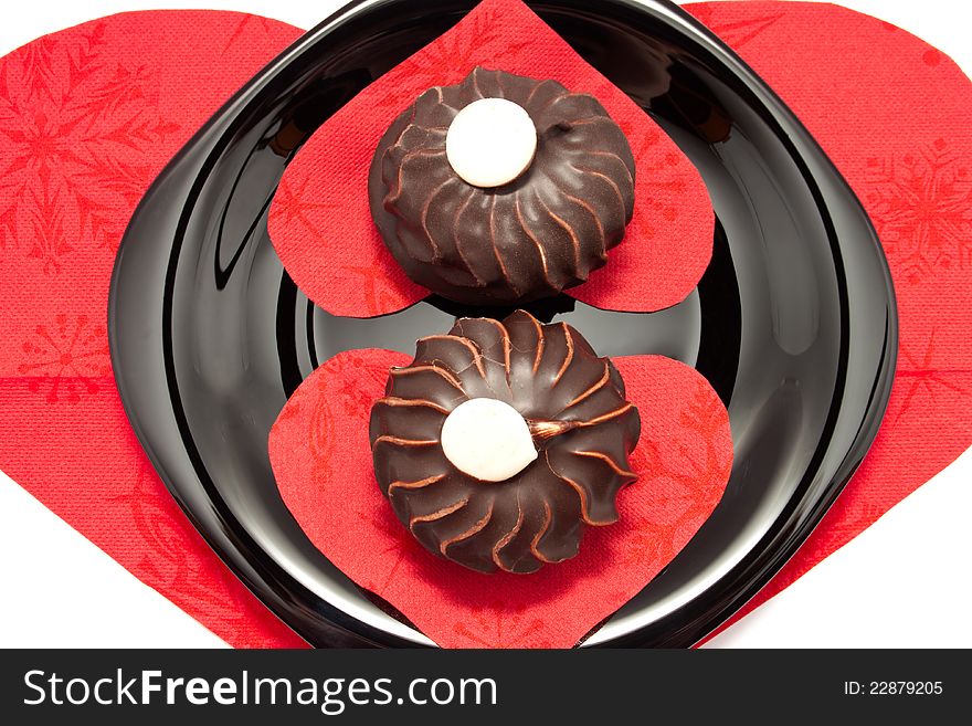 The chocolate cakes on the plate with heart-shaped napkins