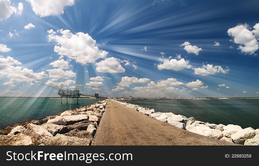 Road on the sea with cloudy sky