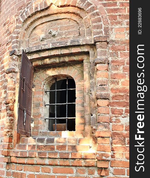 Window with bar in the wall of the medieval building. Window with bar in the wall of the medieval building