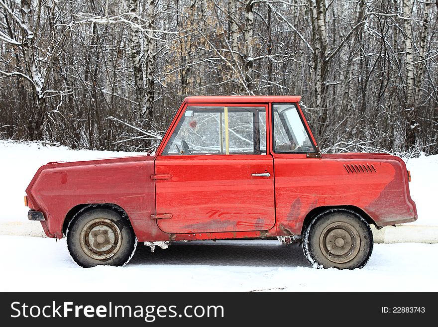 Old red car in the snow