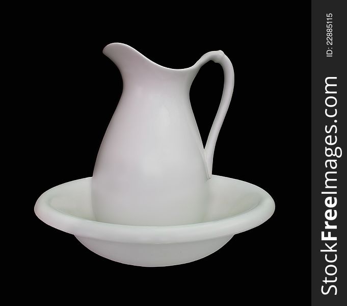 Antique plain white porcelain bowl and pitcher set. Isolated on black. Antique plain white porcelain bowl and pitcher set. Isolated on black.