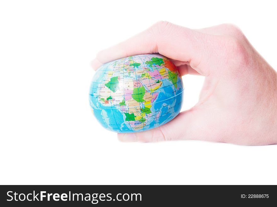 Man's hand compresses the a globe on a white background. Man's hand compresses the a globe on a white background
