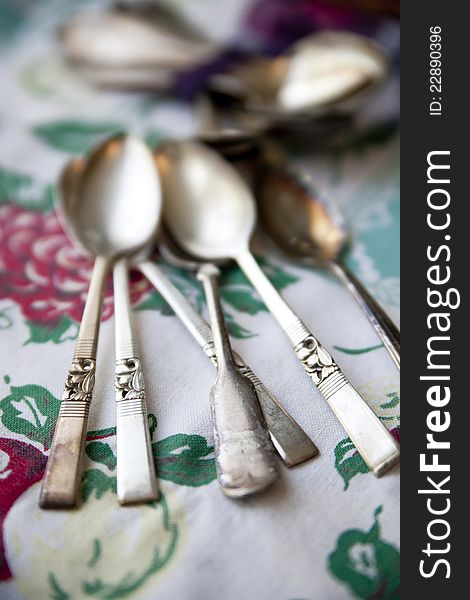 Vintage Silver Spoons On An Antique Tablecloth