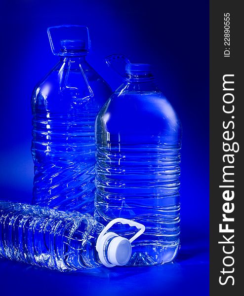 Transpatent bottles on the blue background. Transpatent bottles on the blue background